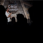 Photo taken at the Comedy Clubhouse during a show, with Matthew performing on stage.