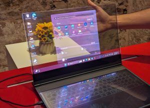 Picture of the laptop in which you can see that it is transparent, as you can see the sunflowers behind the screen.