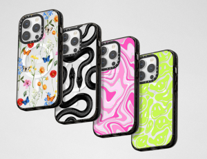 four phone cases with different prints: one mostly pink, one mostly green, one black and white, one different colors